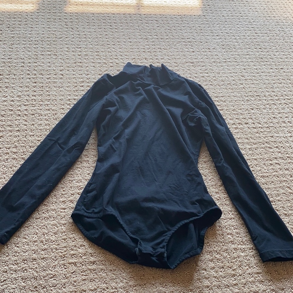 Black open back body suite. Size small. Never worn